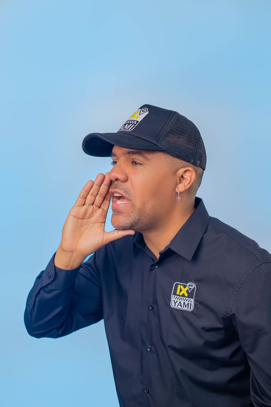 IXI YAMI partner in a branded cap and shirt calling out