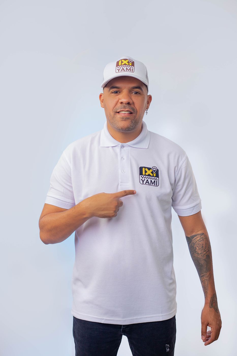 IXI YAMI partner pointing at the logo on his polo shirt