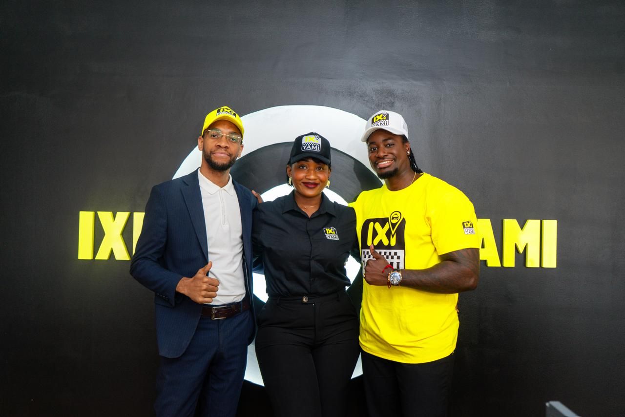 IXI YAMI team and partners in front of the logo